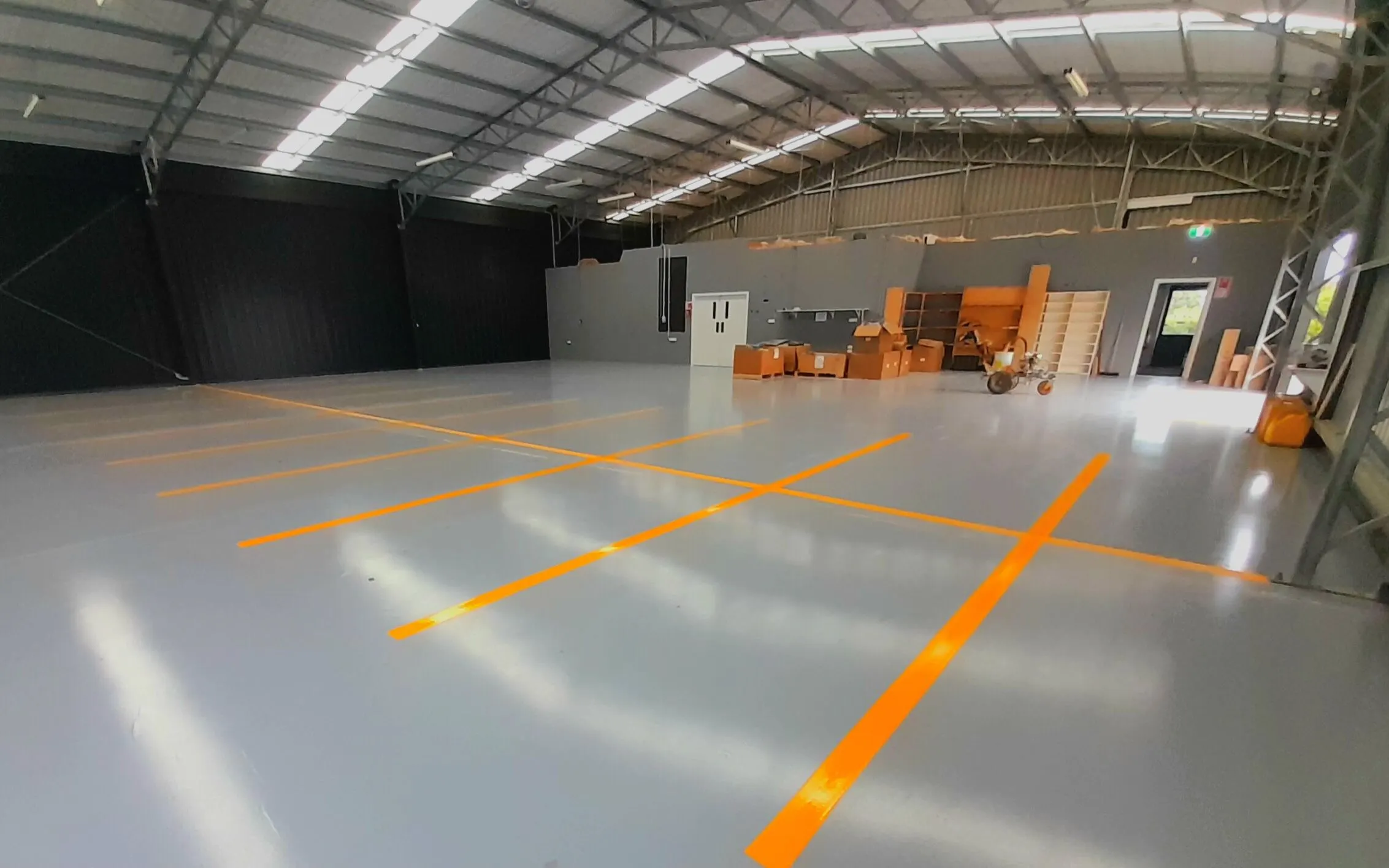 Yellow warehouse floor markings with bay numbering on concrete